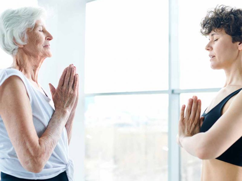 Elderly woman and younger doing workout together