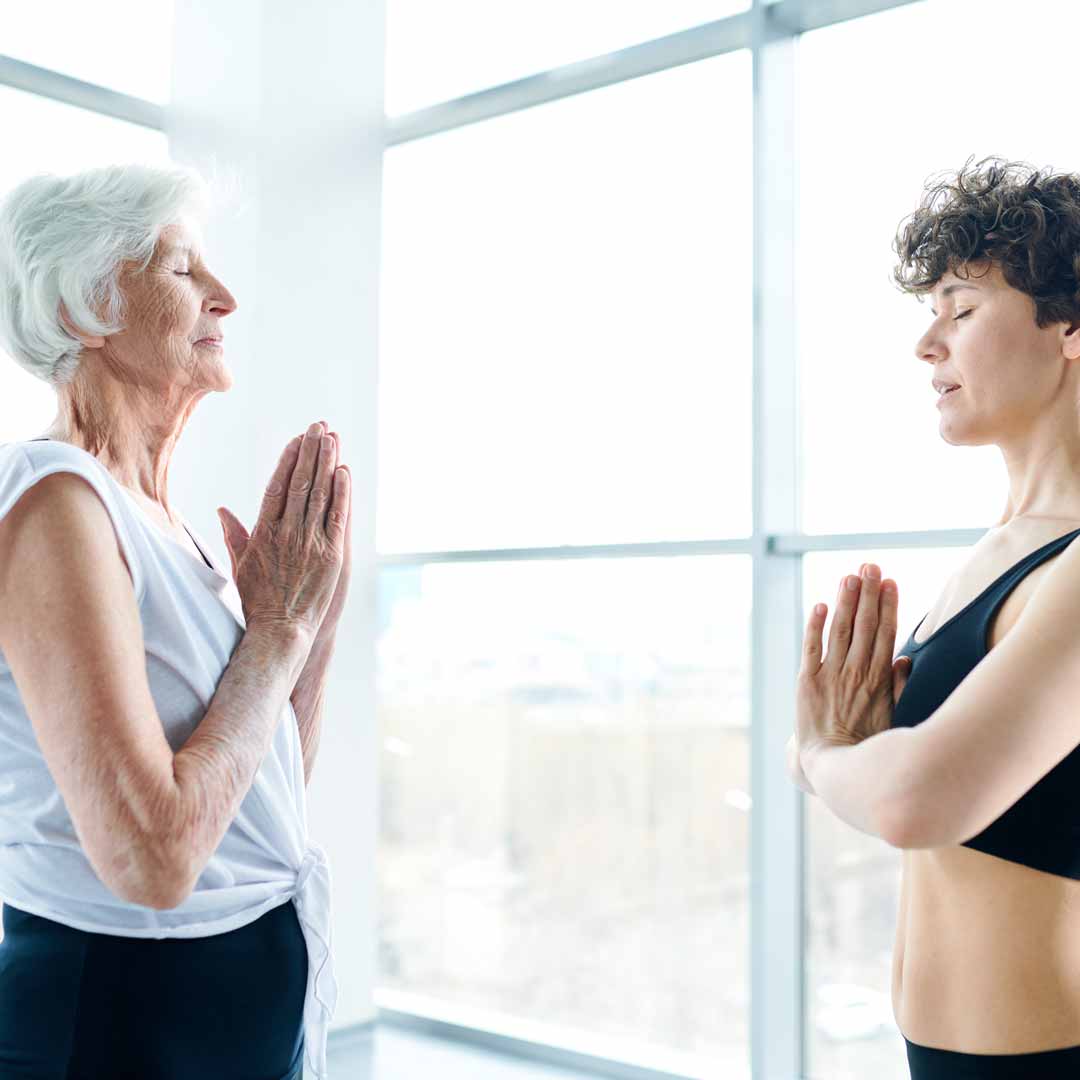 Elderly woman and younger doing workout together