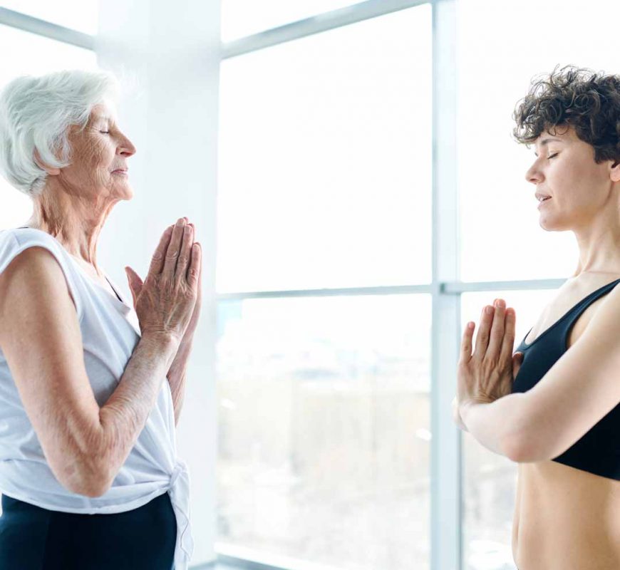 Elderly woman and younger doing workout together